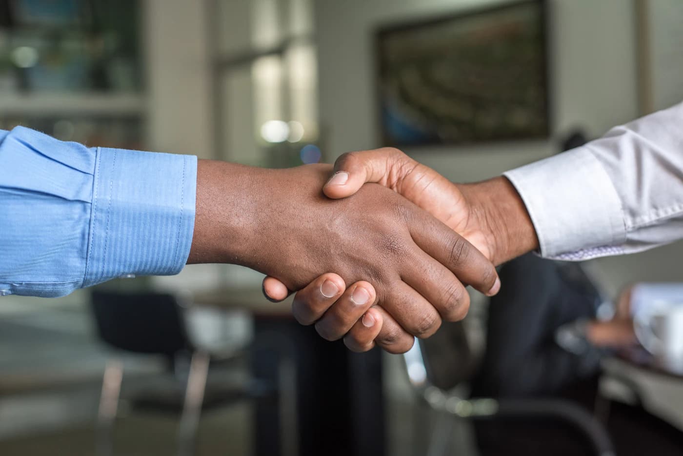 Business partners shaking hands after an agreement