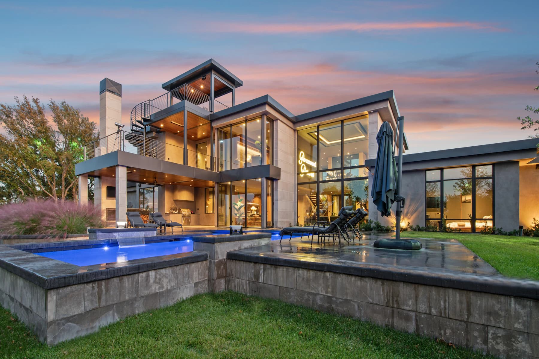 Modern luxury home with a swimming pool at dusk